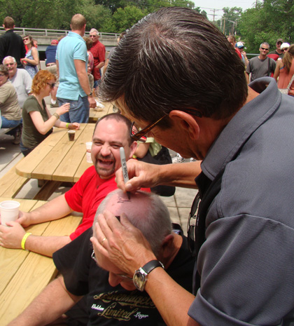 Jake Leinenkugel autographs a fan's head?